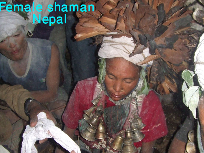 Female shaman in Nepal hanging bells on her neck.